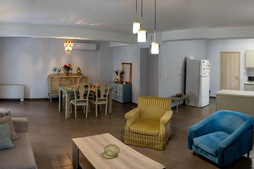 a living room with a table and chairs and a kitchen at Sweet Home near Patras in Patra