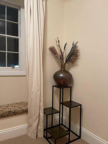 a vase sitting on a wall next to a window at Stunning 3 bedroom House with amazing Castle view in Alnwick