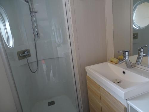 a bathroom with a shower and a sink at Mobile home 6 places camping 5 Vacances Gorges de lArdeche in Lagorce