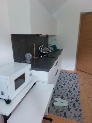 a kitchen with a white microwave on a counter at Apartma Sava-Stol in Jesenice
