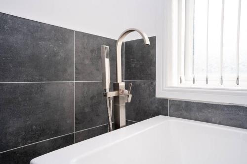 a bathroom with a sink and a faucet at Luxury town apartment with roof terrace, Sleeps 6 in Blackpool