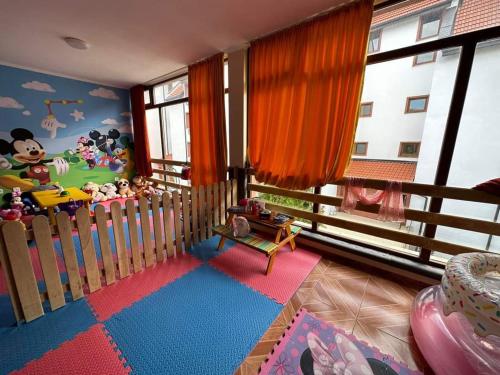 a childs room with a crib and a mickey mouse mural at Famagusta Antoniya in Aheloy