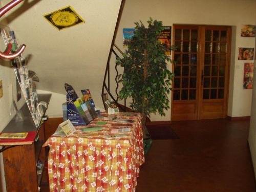 a room with a table with a tree next to a door at La Châtaigneraie in Uzer