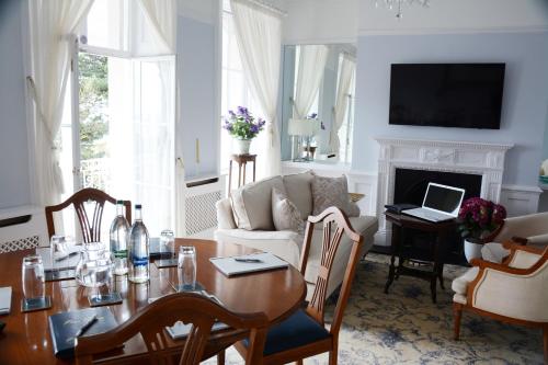 a living room with a table and a couch at Pier View Self Catering Luxury Apartments in Southend-on-Sea