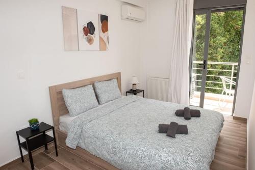 a bedroom with a bed with two brown crosses on it at Bright 2BR apartment in Palaio Faliro-(FAL_A1) in Athens