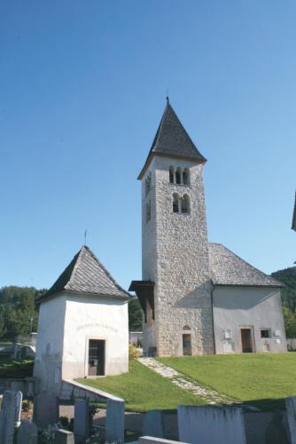 an old church with a tower on a cemetery at Ciasa Erica - Val di Non in Predaia