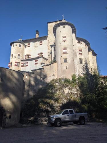 a truck parked in front of a large building at Ciasa Erica - Val di Non in Predaia