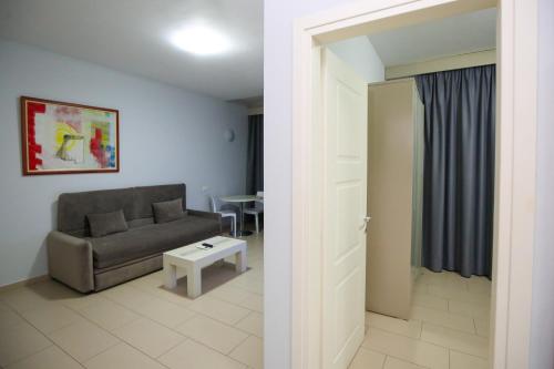 a living room with a couch and a table at Diamond Hill Resort & SPA in Vlorë