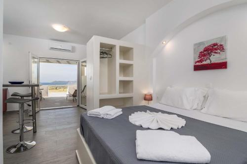 a bedroom with a bed with two towels on it at Sunset Village 5 in Paleochori