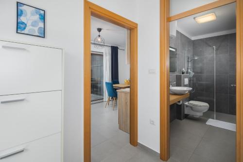 a bathroom with a toilet and a sink at Apartments Špadići in Poreč
