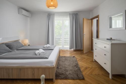 a bedroom with a bed with two towels on it at Apartments Špadići in Poreč