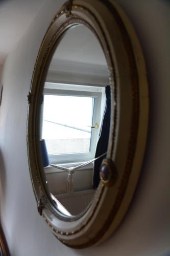 a mirror on a wall with a window at Pier View Self Catering Luxury Apartments in Southend-on-Sea
