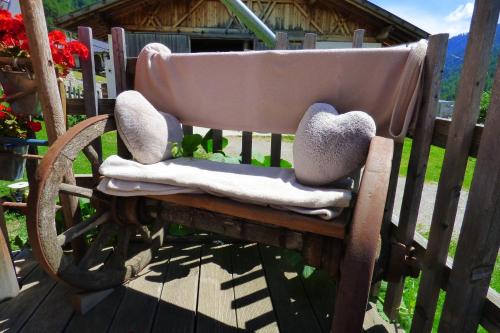 a wooden rocking chair with two hearts on it at Sesvennahof in Malles Venosta