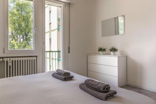 um quarto branco com 2 toalhas numa cama em Treviso to Venice - By Flora em Treviso