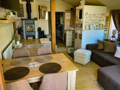 a living room with a table and a couch at Casamia4u in Alsóörs
