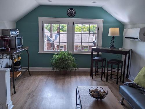 a living room with a table and a window at Downtown Retreat - 1BR Oasis with Parking in Columbus