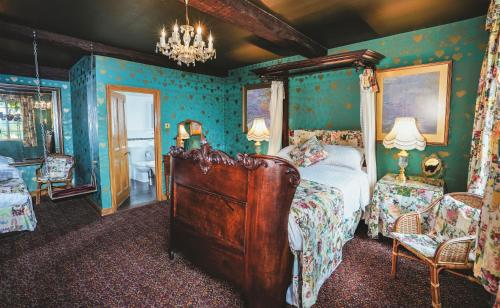 a bedroom with a bed in a room with blue walls at Hundred House Hotel in Ironbridge