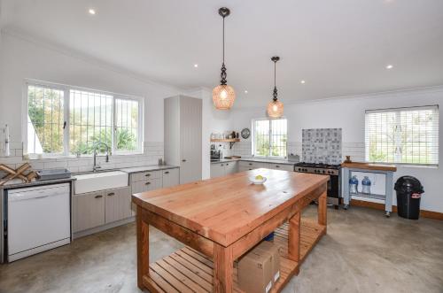 a large kitchen with a wooden table in it at Contreberg Manor House in Darling