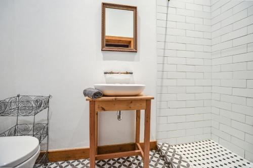 a bathroom with a sink and a mirror on a table at Contreberg Manor House in Darling