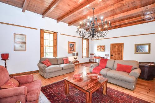 a living room with two couches and a table at Contreberg Manor House in Darling