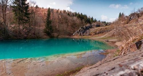 a large blue lake in the middle of a hill at Bungalow-Am-Eichholz in Ilsenburg