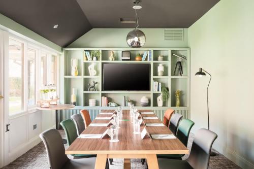 a dining room with a long table and chairs at Holiday Inn Reading West by IHG in Reading