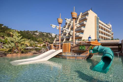 a water slide in the water in front of a hotel at Golden Bahía de Tossa & Spa 4* Sup. in Tossa de Mar