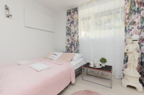 a bedroom with two beds and a table at Sweet Underground Studio close to PGE Narodowy by Renters in Warsaw