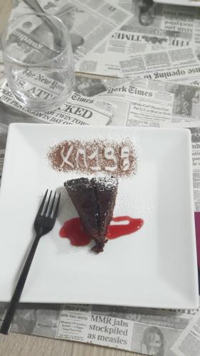 a piece of cake on a plate with a fork at B&B KM 198 - Letto e colazione in Sorbara
