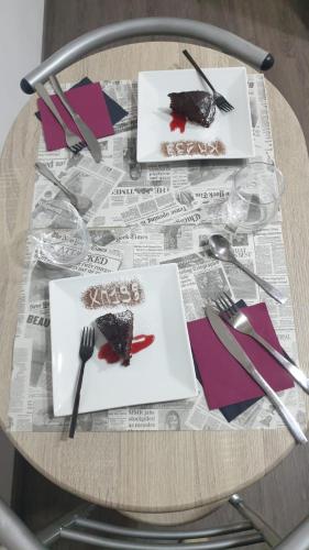 a table with a plate of food on top of a newspaper at B&B KM 198 - Letto e colazione in Sorbara