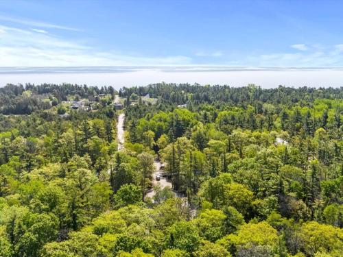 an aerial view of a forest with a house at New, charming custom home in Sturgeon Bay