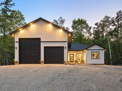 a house with a garage and a driveway at New, charming custom home in Sturgeon Bay