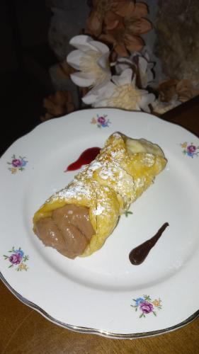 a piece of food on a plate on a table at B&b Diamante and home restaurant in Trentinara