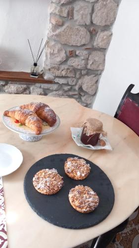 a table with three plates of pastries and bread at B&b Diamante and home restaurant in Trentinara