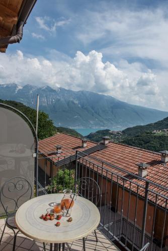a table on a balcony with a view of mountains at Residence La Berna in Tremosine Sul Garda