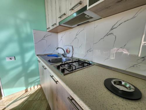 a kitchen with a sink and a counter top at Villa Orange in Vlorë