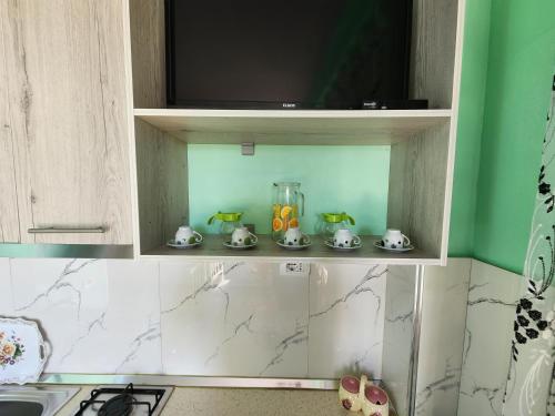 a kitchen cabinet with a kitchen utensils in it at Villa Orange in Vlorë