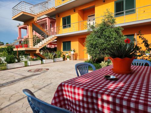 a table with a red and white checkered table cloth at Villa Orange in Vlorë