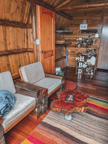 a living room with a couch and a table at Costa Azul Ecolodge in Aquitania