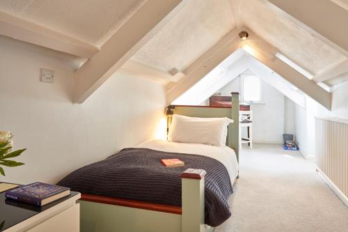 a bedroom with a bed in a attic at Ocean Villas in Marazion