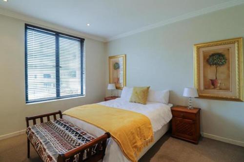 a bedroom with a bed and a window at Luxury joy in Cape Town