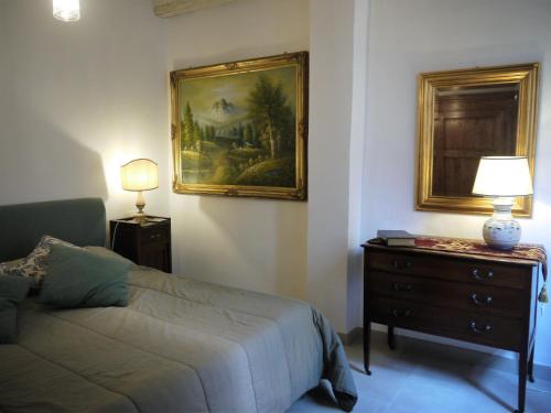 a bedroom with a bed and a painting on the wall at Casa Marzia in Montevarchi