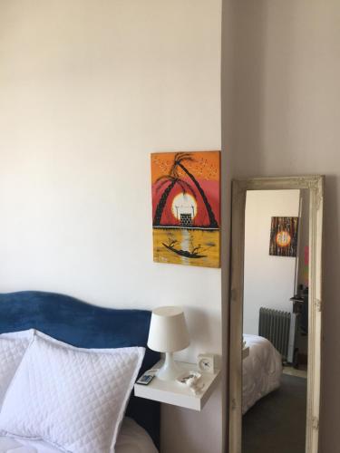 a bedroom with a mirror and a bed and a lamp at private room chambre privée in Kenitra