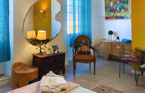 a bedroom with a mirror and a bed and a desk at Palais Hongran de Fiana in Nice
