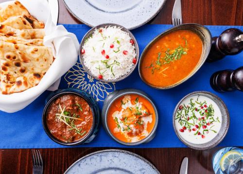 a table topped with bowls of food on a blue table at Park Regis Birmingham in Birmingham