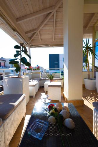 a living room with a couch and a table at Hana apartament hot tub in Vlorë