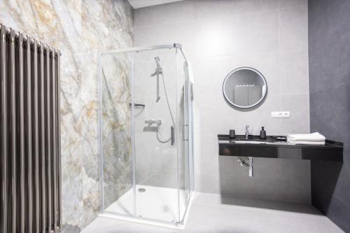 a bathroom with a shower and a sink at Royal Apartments Liptovsky Mikulas in Liptovský Mikuláš