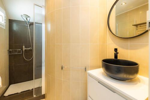 a bathroom with a bowl sink and a shower at Sa Figuereta Beach in Playa de Muro