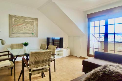 salon ze stołem i kanapą w obiekcie Apartamento Porto do Xufre w mieście Isla de Arosa