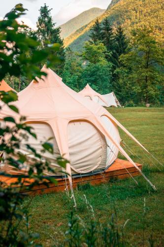 a couple of tents sitting in a field at Glamping Gozdna Jasa in Bovec